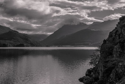 Scenic view of sea and mountains against sky