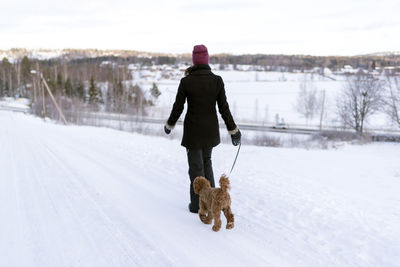 Rear view of woman on snow