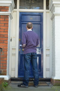 Rear view of man standing outside building