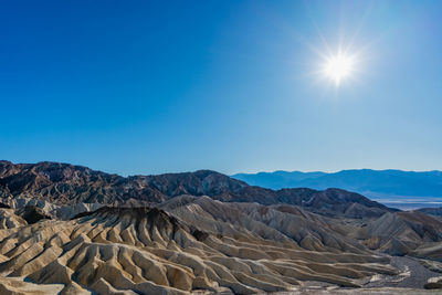 Scenic view of rocky mountains against blue sky