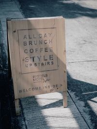 High angle view of text on footpath by street