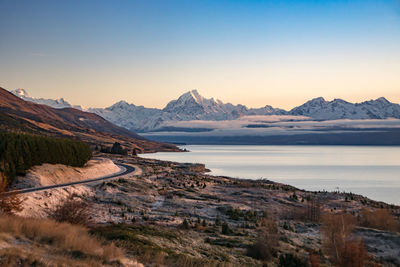 Scenic view of landscape against clear sky during sunset