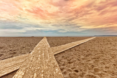 Scenic view of beach against sky during sunset