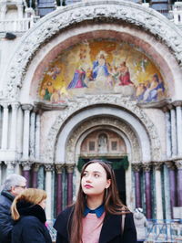 Woman standing in front of temple