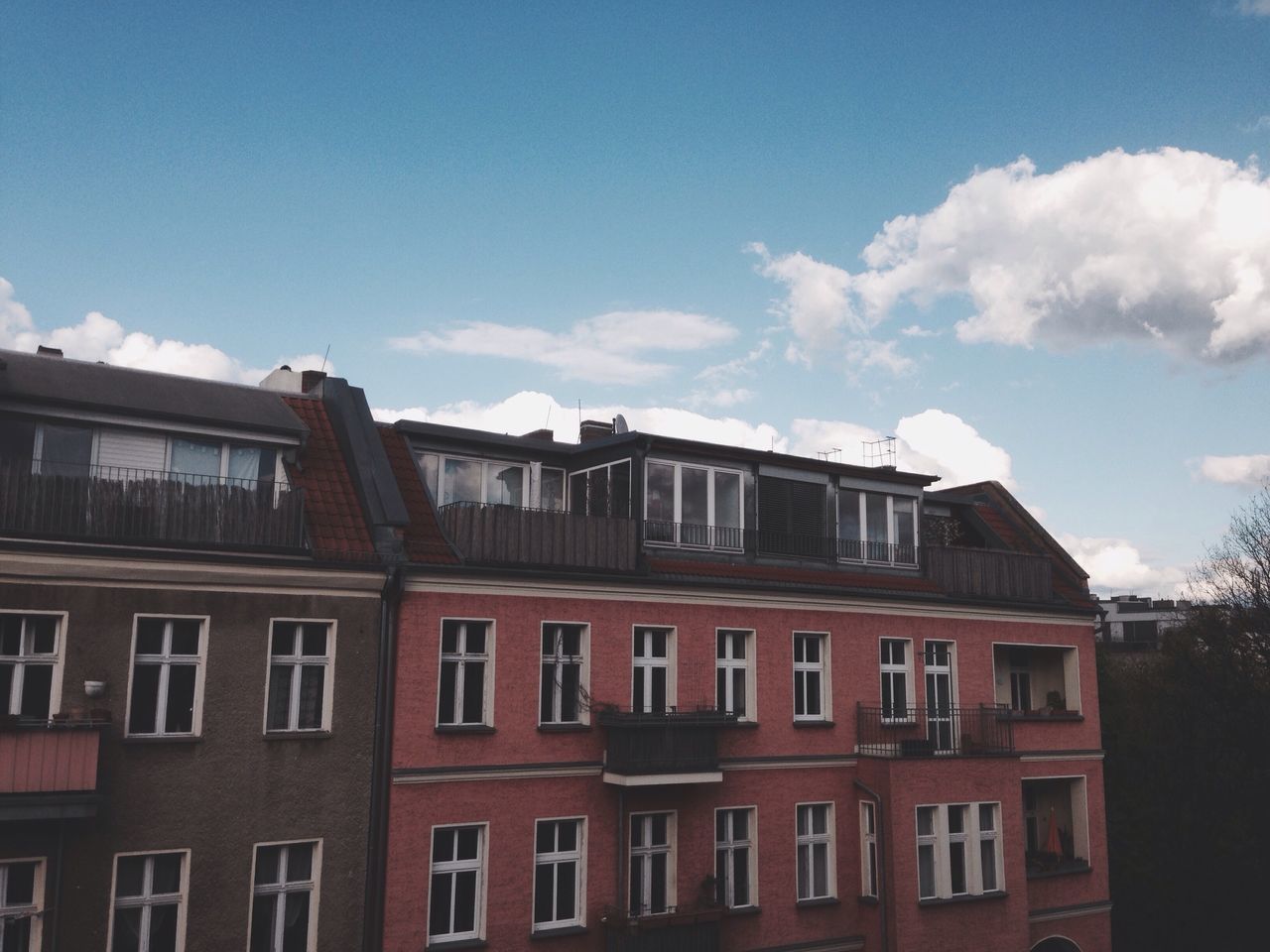 architecture, building exterior, built structure, window, sky, low angle view, residential building, residential structure, building, blue, house, day, city, cloud, outdoors, cloud - sky, no people, balcony, sunlight, facade