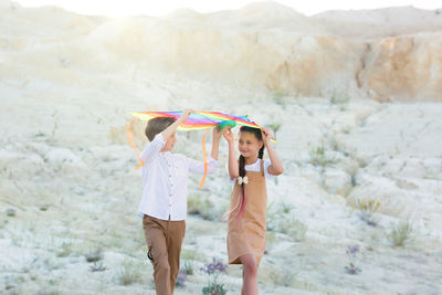 Rear view of woman holding umbrella