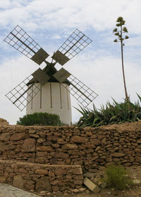 Traditional windmill against sky