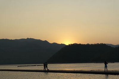 Silhouette of people at sunset