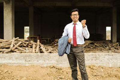 Portrait of man standing at construction site