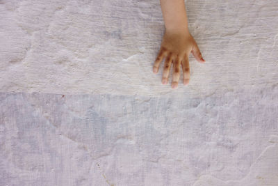 High angle view of hand on floor