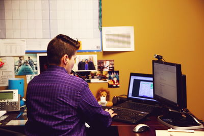 Woman using computer while sitting at office desk