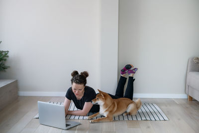 Two dogs sitting on laptop