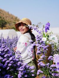 Portrait of smiling woman with purple flowers