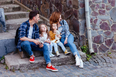 Happy family sitting outdoors