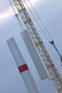 Low angle view of crane against sky