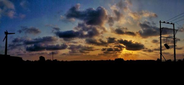 Low angle view of silhouette landscape against dramatic sky