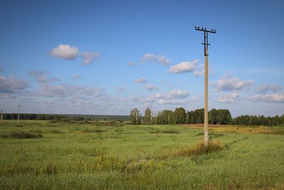 Electricity pylon on field against sky