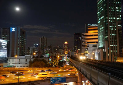 Illuminated cityscape against sky at night