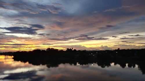 Scenic view of lake against romantic sky at sunset