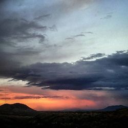 Scenic view of mountains against cloudy sky