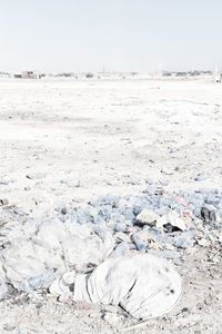 Scenic view of snow covered land against clear sky