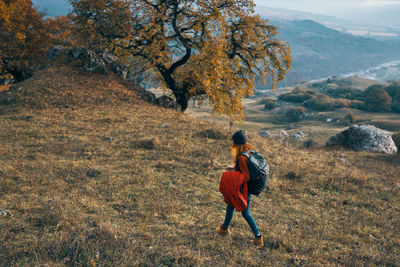 Rear view of woman walking on mountain