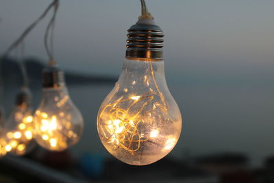 Close-up of illuminated light bulb