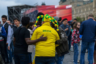 Rear view of people standing on street