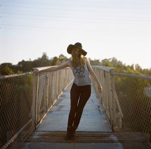 Full length of woman standing by railing