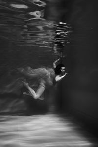 Blurred motion of woman swimming in pool