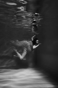 Blurred motion of woman swimming in pool