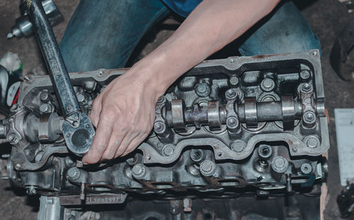 Low section of man repairing car