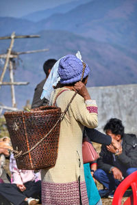 Rear view of woman standing against sky