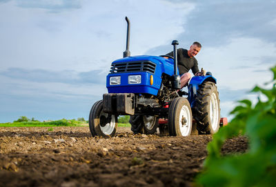 A farmer on a tractor works in the field. milling soil, crushing and loosening ground 