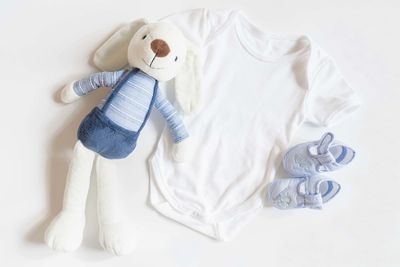 High angle view of stuffed toy on bed against white background