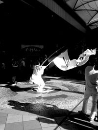 Full length of woman standing by railing
