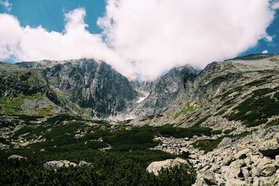 Scenic view of mountains against cloudy sky