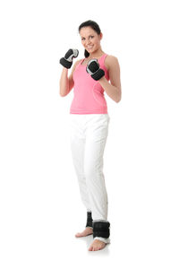 Portrait of smiling young woman standing against white background