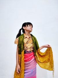 Portrait of woman standing against white background