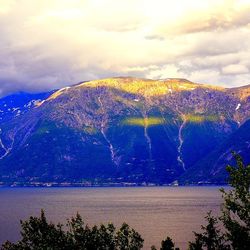 Scenic view of mountains against cloudy sky