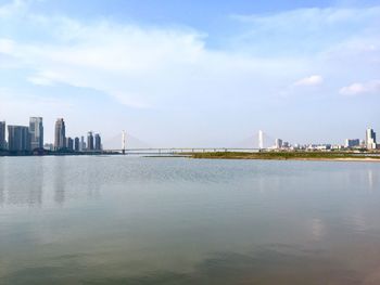 Bridge over river with city in background