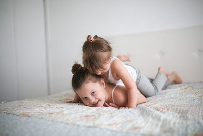 Sister's girls play and hug, emotions. concept childhood and related relationships, lifestyle