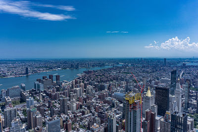 High angle view of city by sea against sky