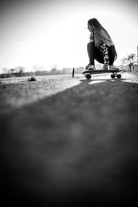 Side view of a woman riding bicycle on city