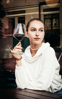 Portrait of a man drinking glass in restaurant