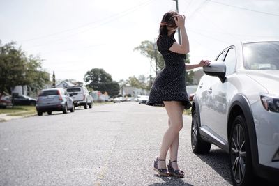 Full length of woman standing on road