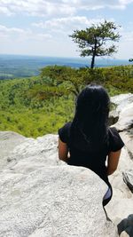 Rear view of woman looking at view against sky