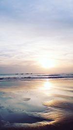 Scenic view of beach against sky during sunset