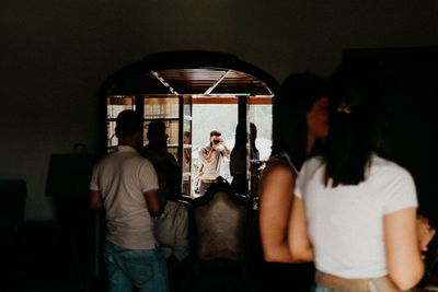 Rear view of man standing at home