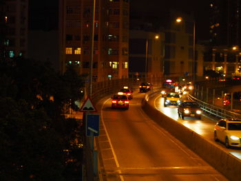 Cars on road in city at night